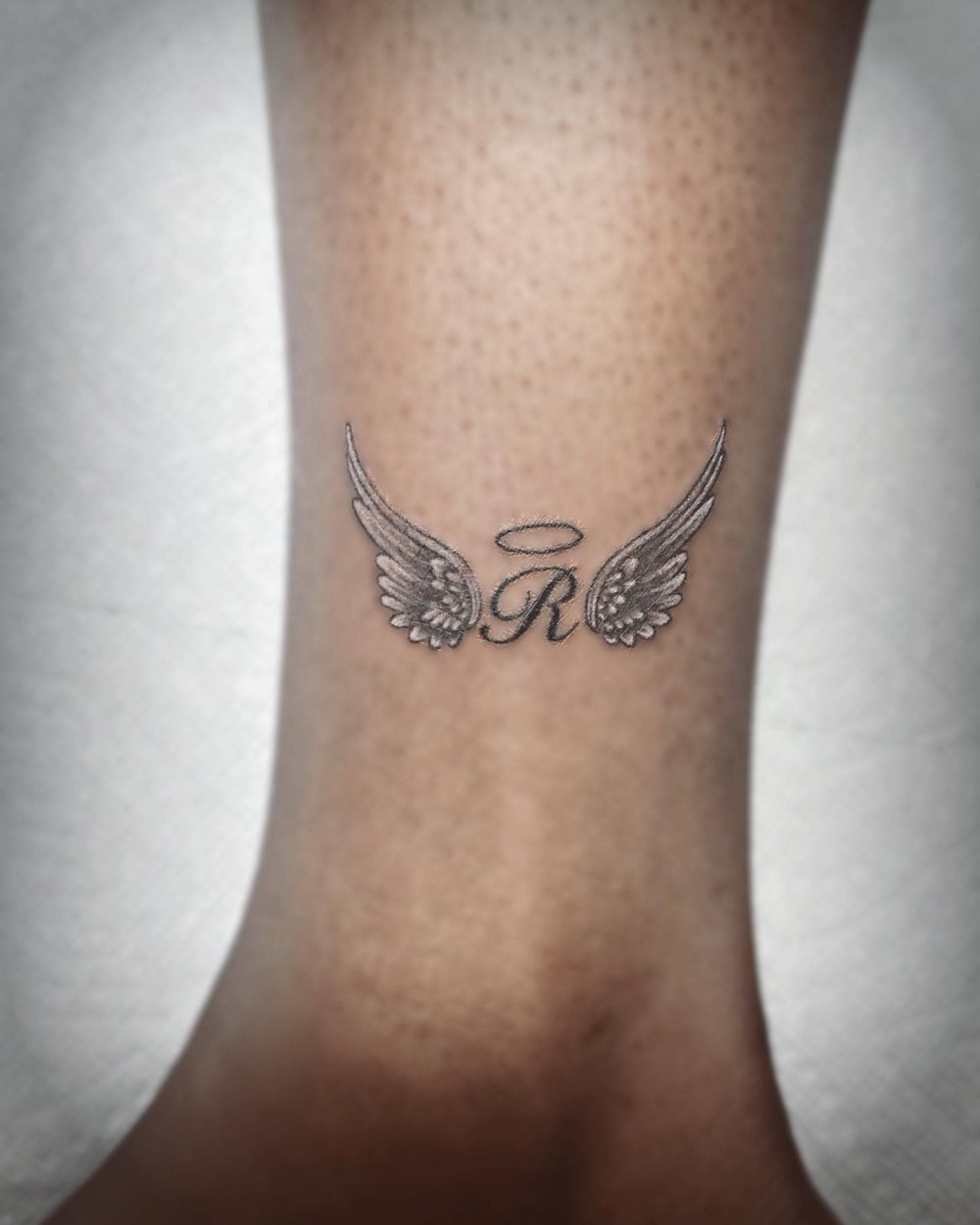 realistic-memorial-lettering-micro-angel-wing-tattoo-alfred_tatts
