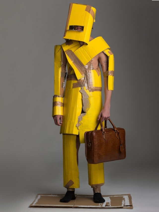 men wearing yellow paper cloth with bag