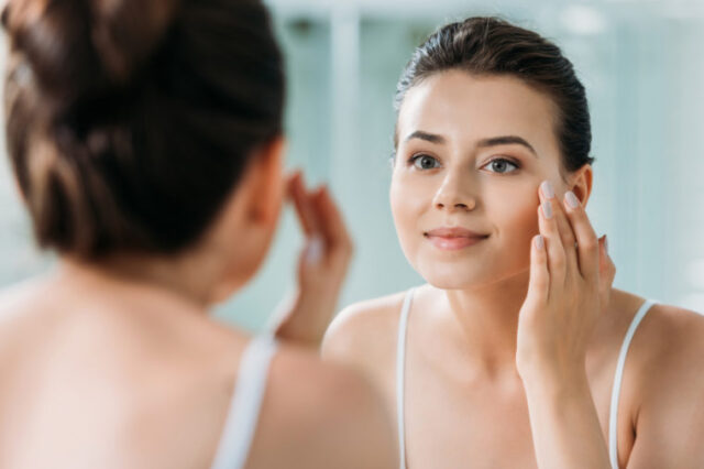 woman mirror face wrinkle cream