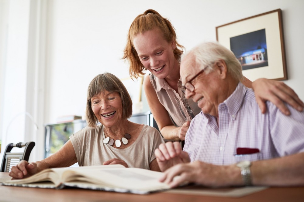 what causes grey hair | family looking through photo album