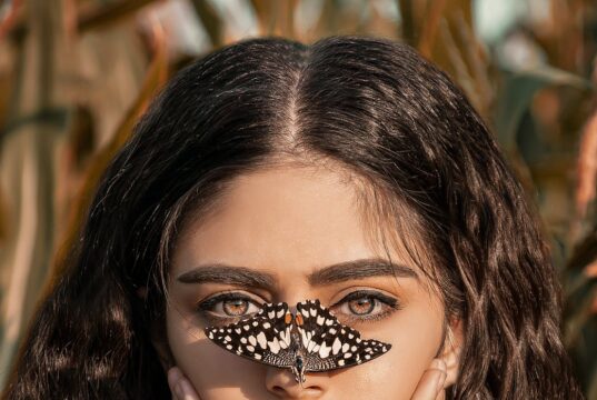 beautiful woman with butterfly on her nose