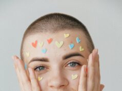 young positive woman with many stickers on face