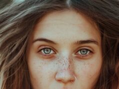 beautiful woman with freckles looking at camera