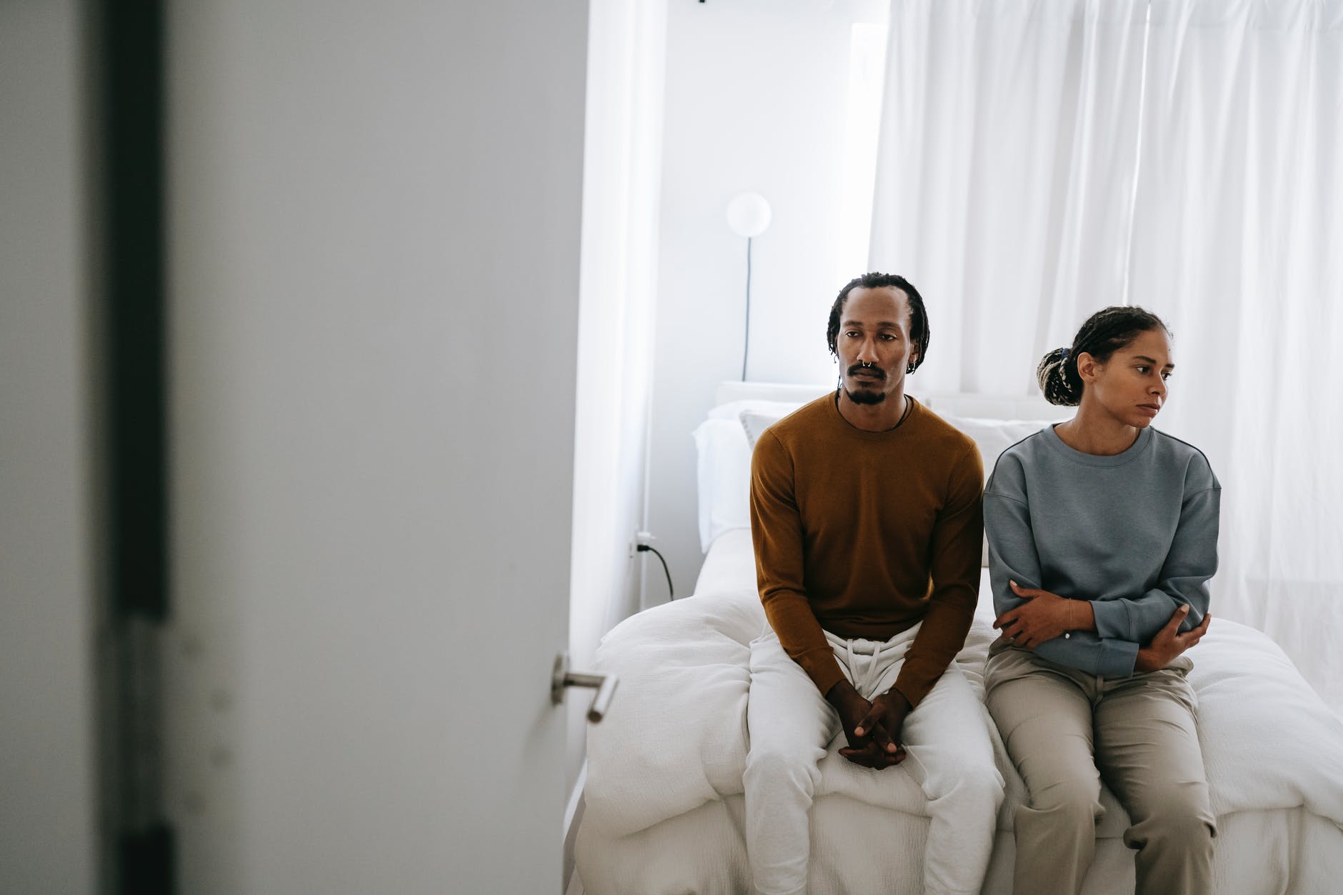 black couple spending time on bed at home